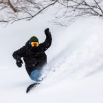 Snowboarder riding the famous powder snow of North Japan