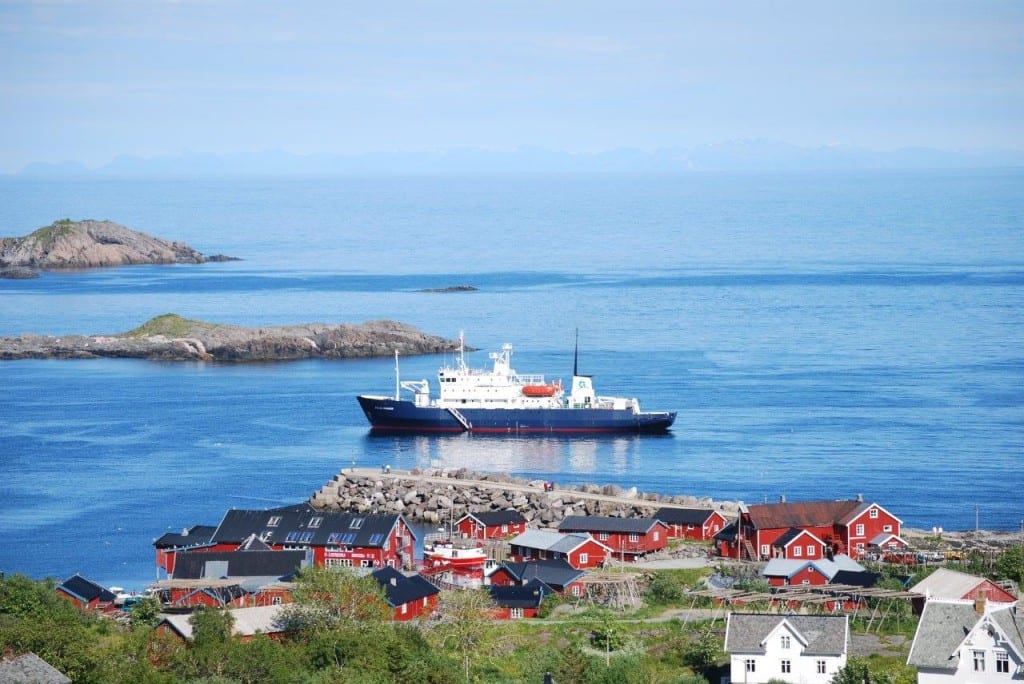 Polar Pioneer cruising past a fishing village in Norway - Aurora Expedit...