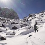 30 Dave looking for the best route through a snowy boulder field en route to Dvoinoi Pass – Rich Emerson