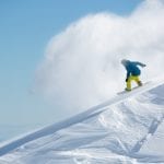 Snowboarder with snow spray