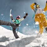 Happy couple snowboarders having fun