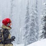 Woman looking up at snow falling at Revelstoke Mountain Resort