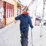 A skiier walking in downtown Rossland